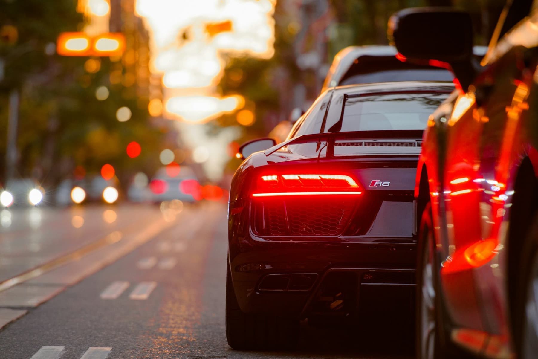 Evening city light with car silhouette — used as backdrop, heavily desaturated and darkened.